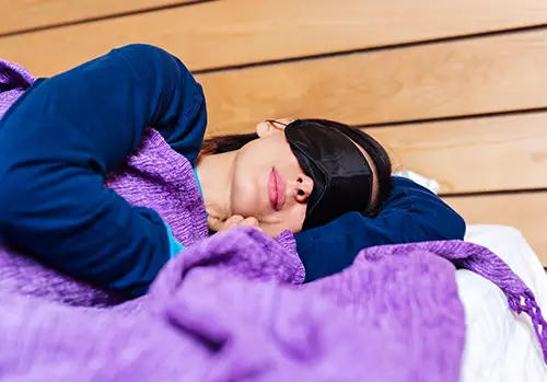 Portrait of middle age woman using eye mask for better sleep.