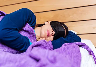 Portrait of middle age woman using eye mask for better sleep.