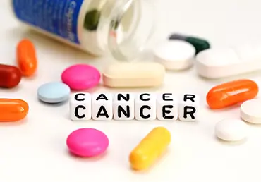 word cancer surrounded by pills