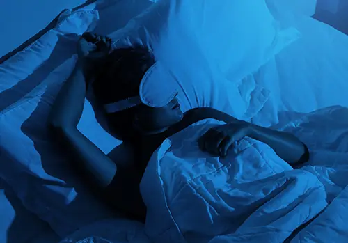 Woman sleeping with a sleep mask on her eyes