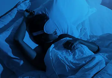 Woman sleeping with a sleep mask on her eyes