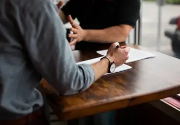 two men reviewing documents