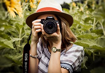 A woman uses a photography camera.