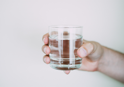 A full glass cheering to the benefits of water.