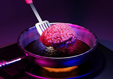 A cartoon brain is being lifted out of a frying pan with a spatula.