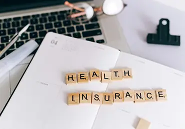 Health Insurance is spelled out with lettered tiles.