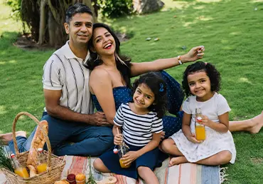 A happy family enjoying a picnic knowing they are protected by aca health insurance.