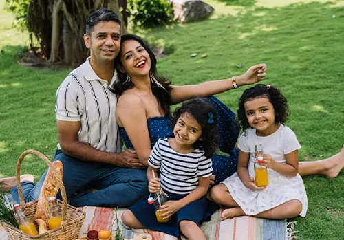 A happy family enjoying a picnic knowing they are protected by aca health insurance.