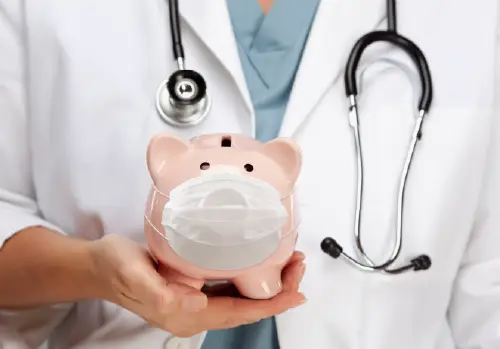 hsa vs fsa whats the difference doctor holding piggy bank with a medical mask large image