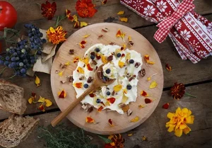 Butter board food trend, butter spread on wooden board with sweet toppings of honey and pecans