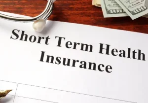 Short term health insurance policy on a table.