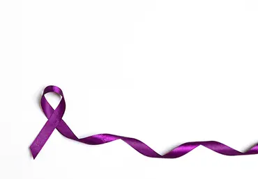 Purple epilepsy awareness ribbon on a white background with copy space.
