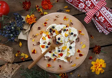 Butter board food trend, butter spread on wooden board with sweet toppings of honey and pecans