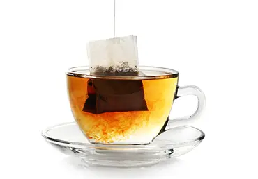 Cup with bag of tea.
