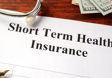 Short term health insurance policy on a table.
